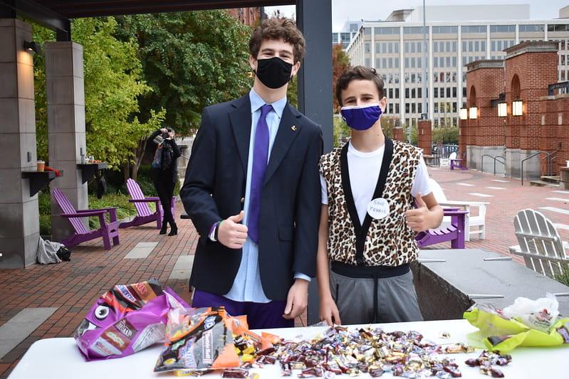 As part of an SGA initiative, Seniors Timmy and Conor Shaheen help pass out treats to students in Xavier cohort on Halloween. 