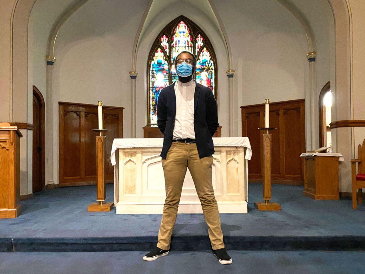 First-year teacher Mr. Christopher Smith, SJ, poses in front of the altar on the school chapel. (Photo by Jesse Dolojan)