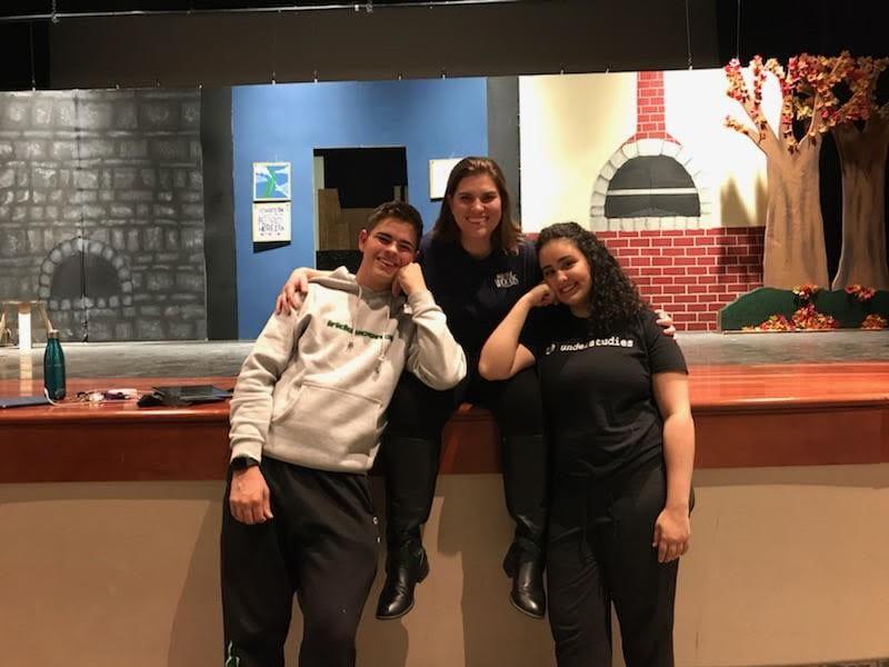 Ms. Kate Griffith poses for a photo with two actors following Academy of the Holy Cross' production of Into The Woods. Ms. Griffith came to Gonzaga from Holy Cross. (Photo submitted from Ms. Kate Griffith)