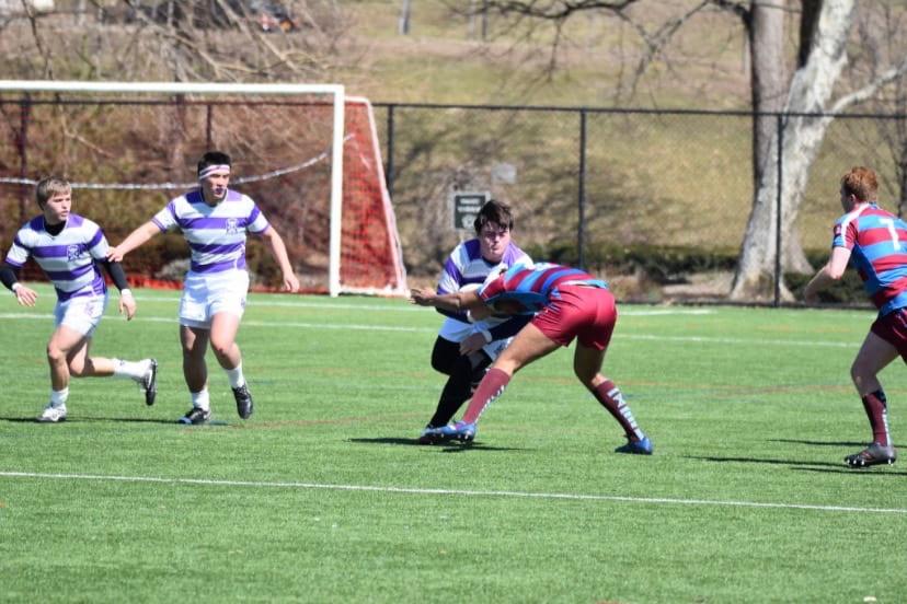 Declan Dolan carries the ball trucking through and opponent tackler. (Photo by Gonzaga Rugby)