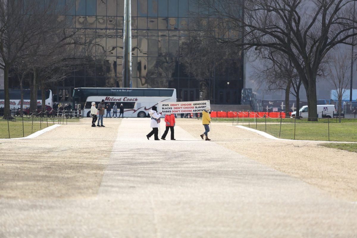 Protestors March with a banner towards the March For Life. Photo By William Malley