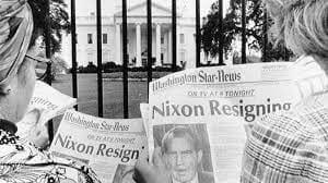 Two women stand outside the White House, reading a freshly published newspaper article about President RIchard Nixon's resignation. Photo by Bettmann