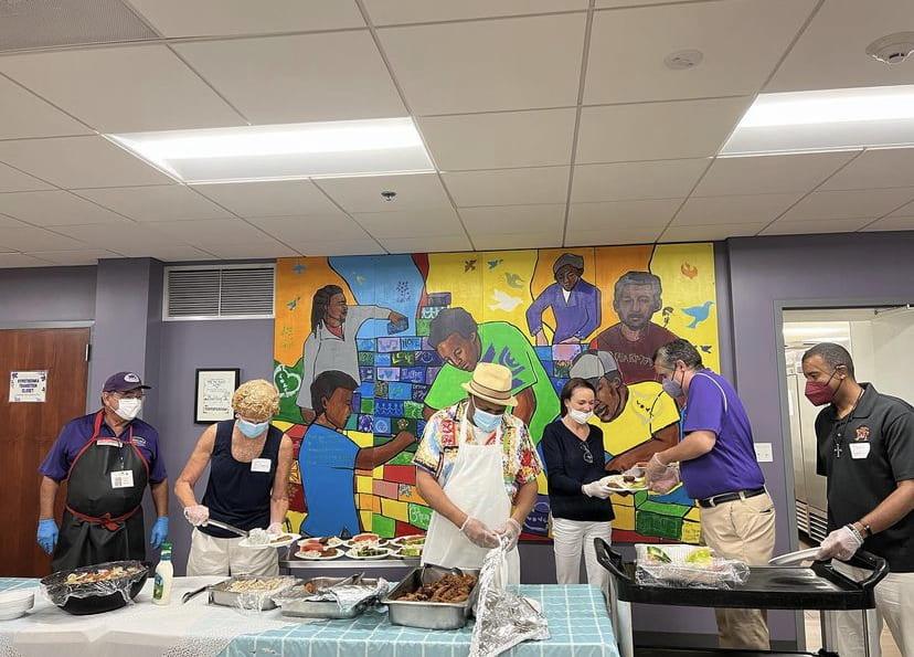 The Father McKenna Center is located under St. Aloysius Catholic Church. Volunteers posed here serving  a meal. Photo from @thefathermckennacenter on Instagram