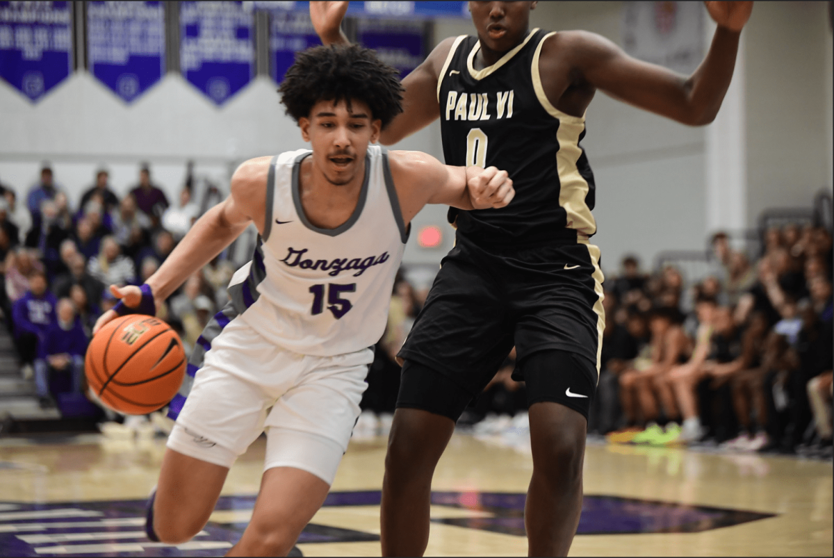 Thomas Batties, senior, drives to the basket during the game against PVI. Photo from PurpleHoops Flickr.