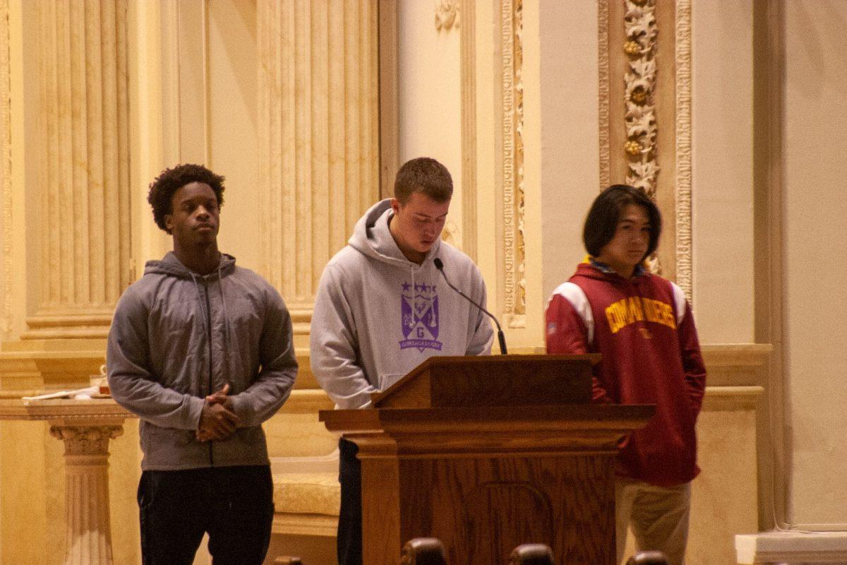 Seniors Jamieson Craig, Jalen Bogues and Nick Gaston lead the stations of the cross with a Racial Justice focus.  Photo by John Broome/Photo II