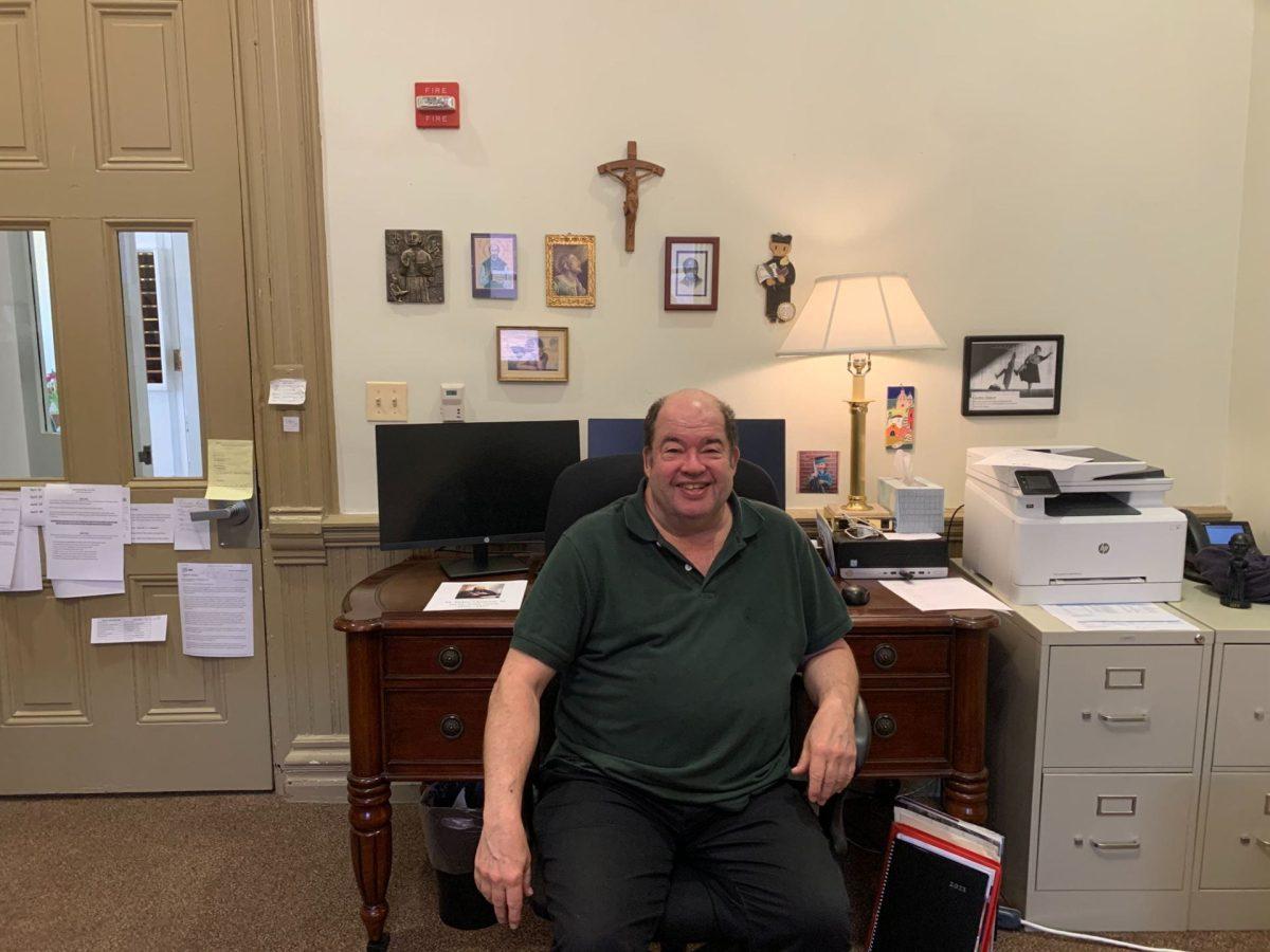 Fr. Harry Geib, SJ, works in his office near the headmaster's office in Dooley Hall.