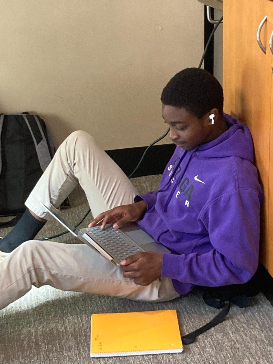 Student Leo Maques Da Costa listens to music in a break. Photo by Colin Clark