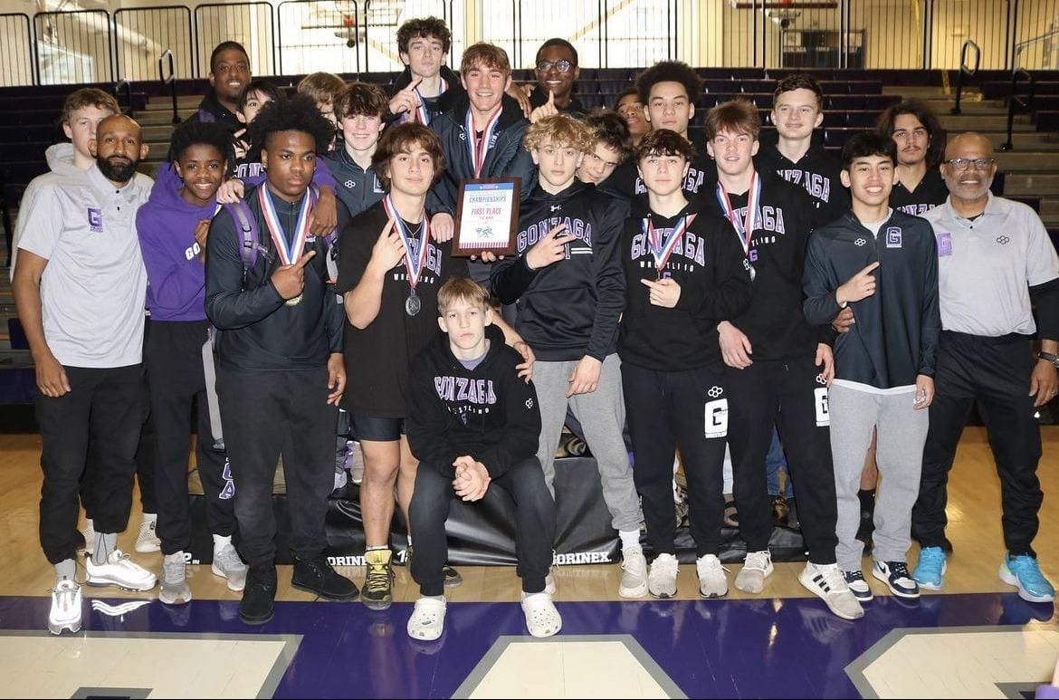 The wrestling team poses after dominating their way to a D.C. Championship.