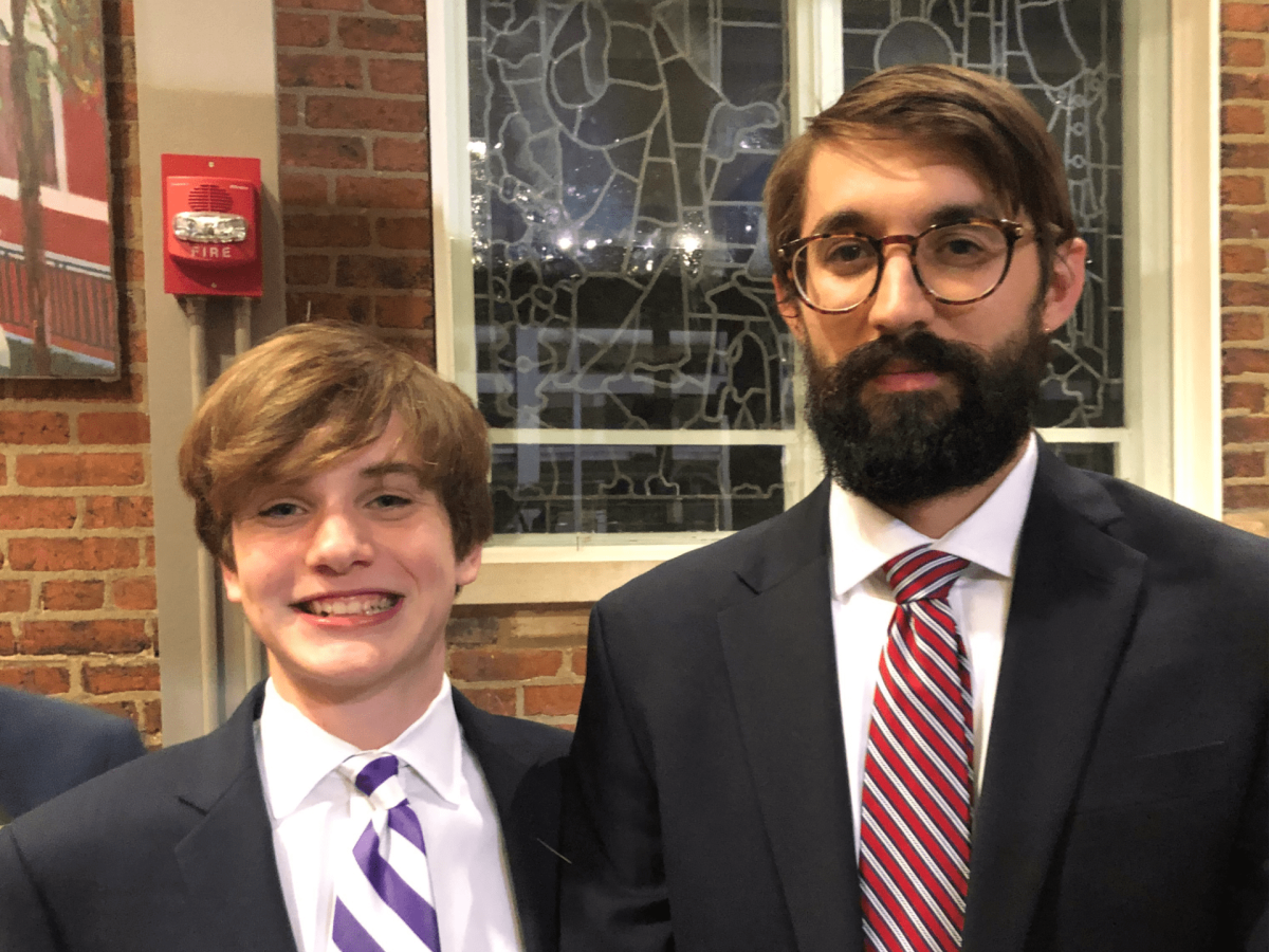  Jon Bouker, senior,  poses with Mr. Dominic Pugliese, social studies teacher, at the 2019 freshman year homecoming dance. Photo by Jon Bouker