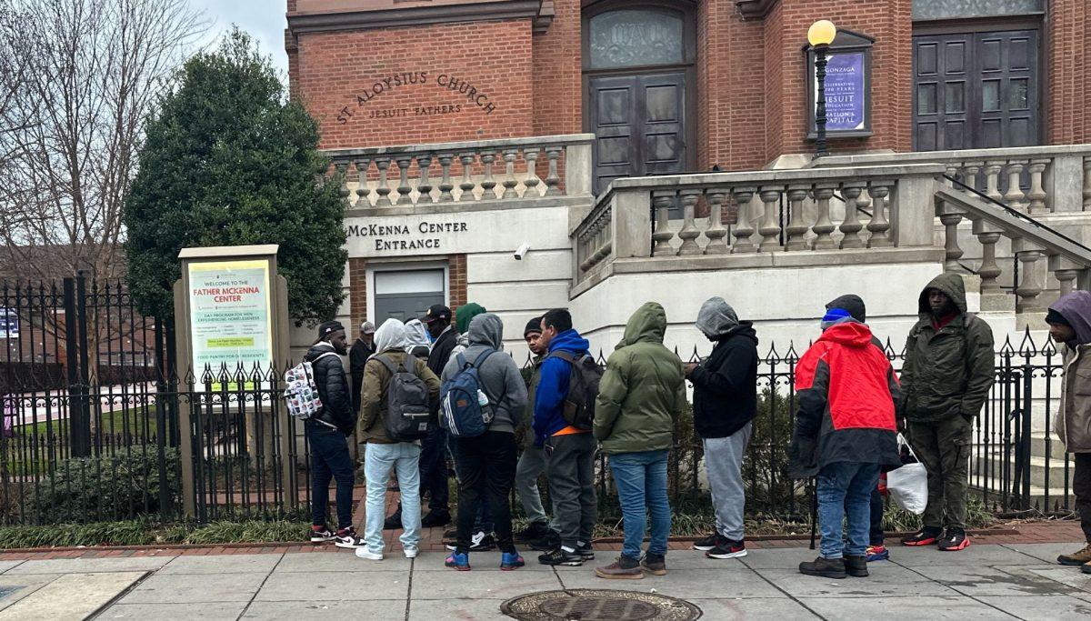 The line of men out the door for breakfast service on a brisk morning. 