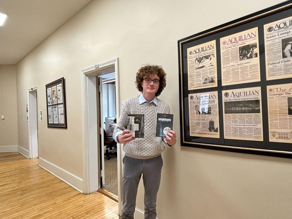 Charlie Slusher holds DVDs of some of his favorite films.